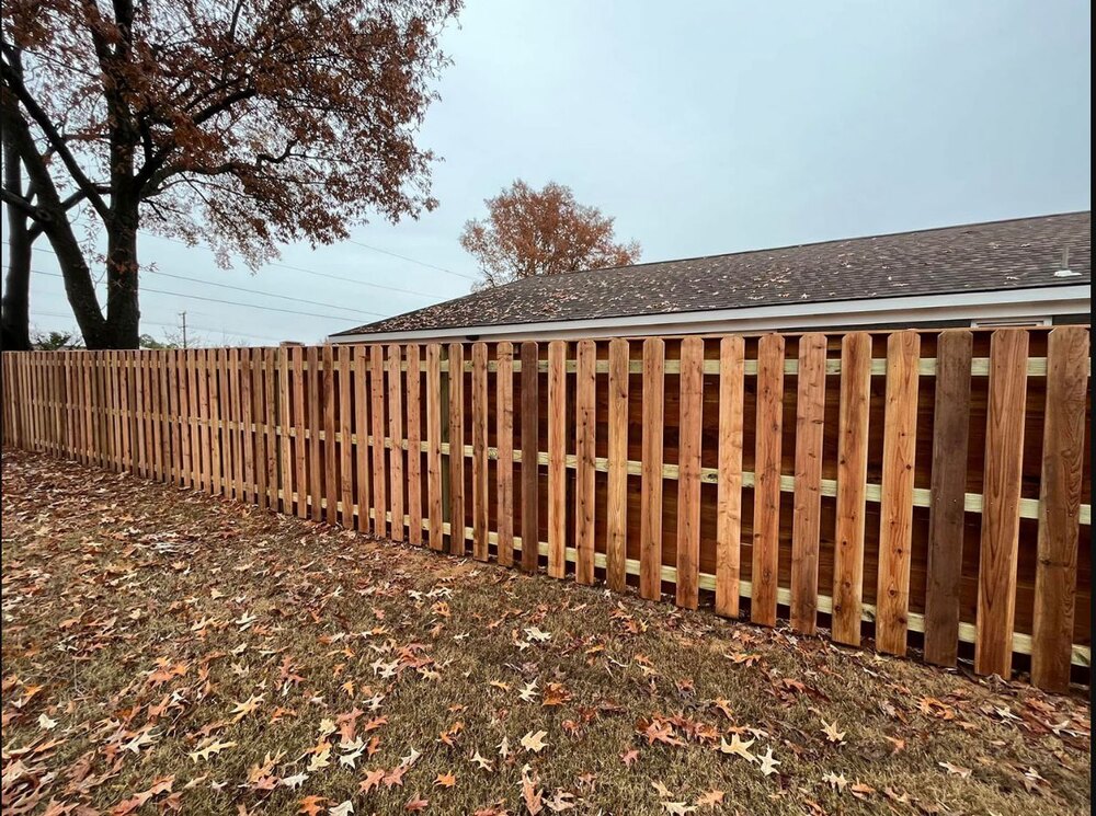 Completed wood picket fence across a residential yard